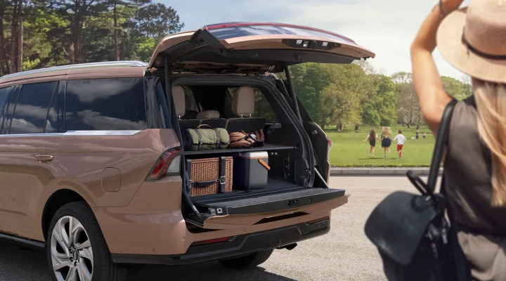 an opened trunk brown lincoln navigator showing space