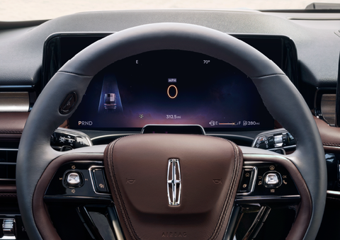 The steering wheel of 2025 Lincoln Aviator® SUV is shown with black and brown accents. | Rogers Lincoln in Midland TX