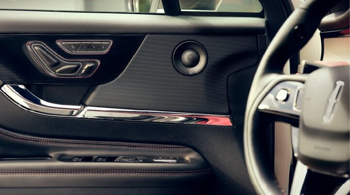 A Revel® audio speaker is shown in the driver's side door of a 2025 Lincoln Corsair® SUV. | Rogers Lincoln in Midland TX
