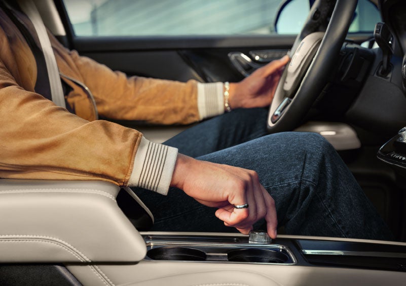 The driver of a 2024 Lincoln Corsair® SUV is shown selecting the drive mode. | Rogers Lincoln in Midland TX