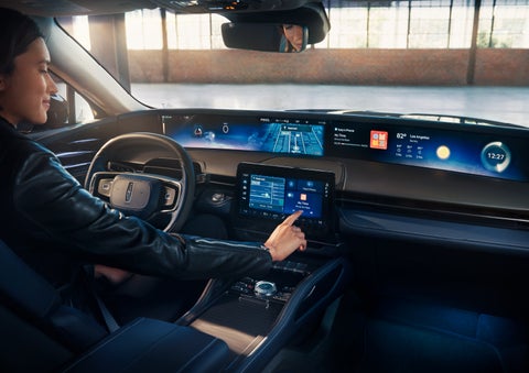 The driver of a 2025 Lincoln Nautilus® SUV interacts with the center touchscreen. | Rogers Lincoln in Midland TX