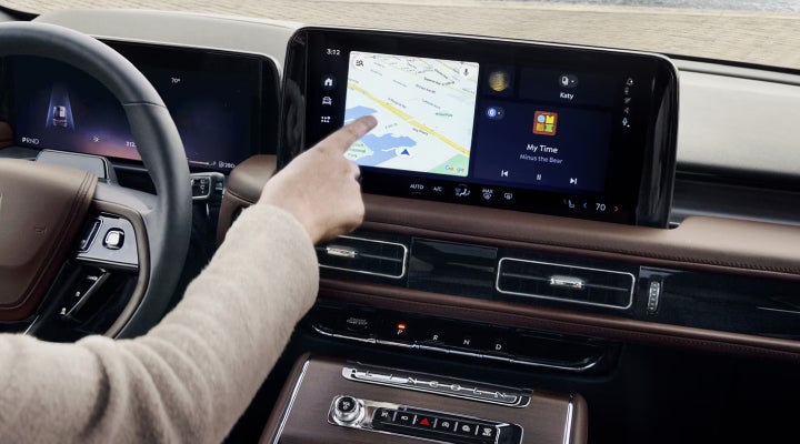 A person is tapping the center display touchscreen of a 2026 Lincoln Aviator® SUV. | Rogers Lincoln in Midland TX
