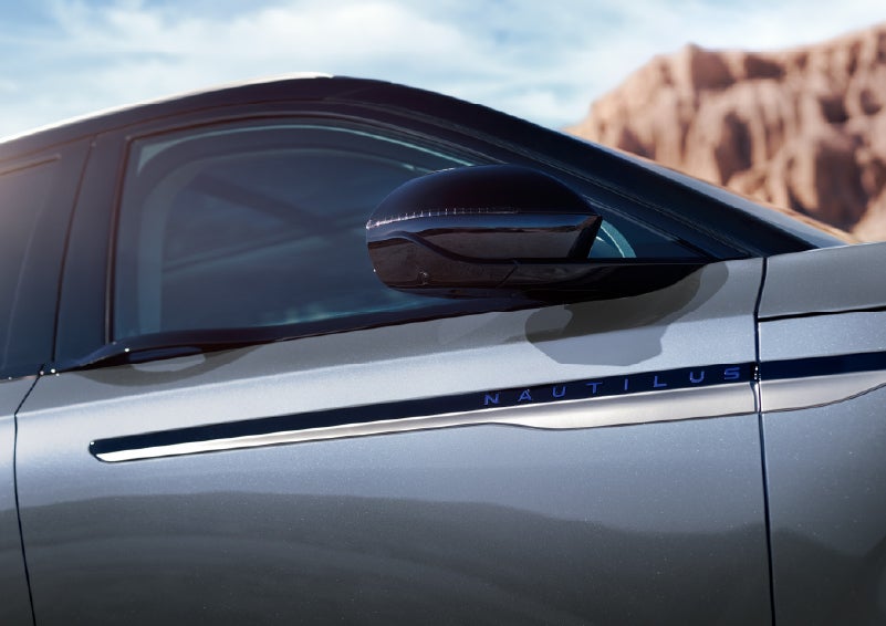 Blue lettering on the side of the vehicle that reads Nautilus indicates the available Hybrid Powertrain. | Rogers Lincoln in Midland TX