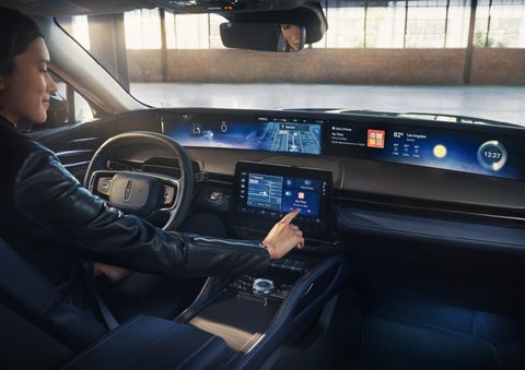 The driver of a 2026 Lincoln Nautilus® SUV interacts with the center touchscreen. | Rogers Lincoln in Midland TX