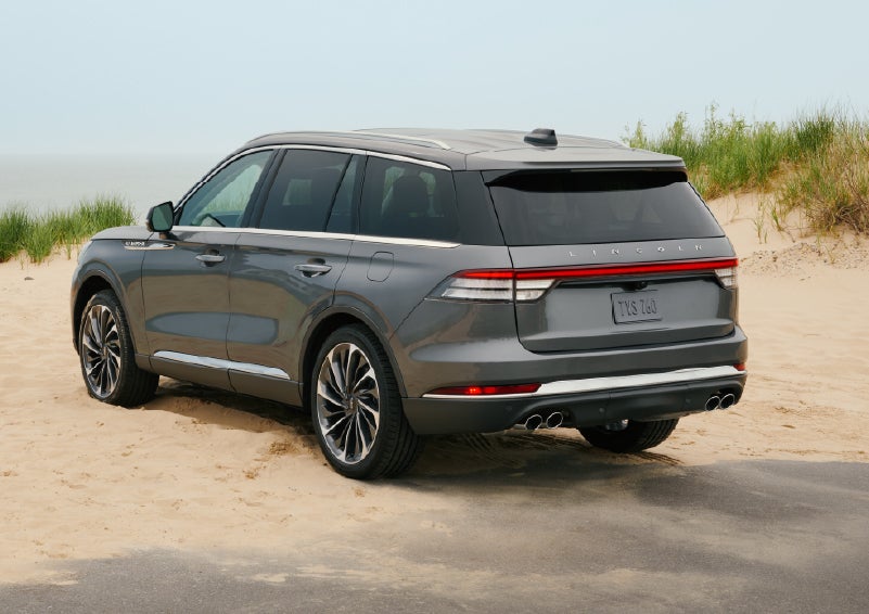 A 2027 Lincoln Aviator® SUV is parked next to sand dunes. | Rogers Lincoln in Midland TX