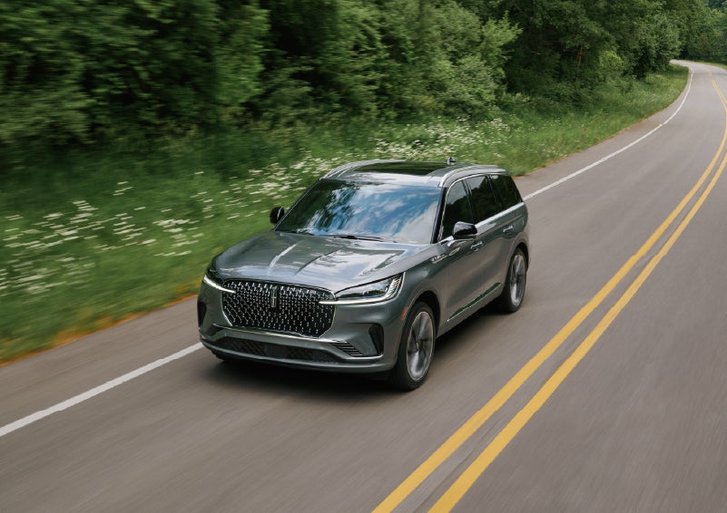 A 2027 Lincoln Aviator® SUV is being driven down a road. | Rogers Lincoln in Midland TX