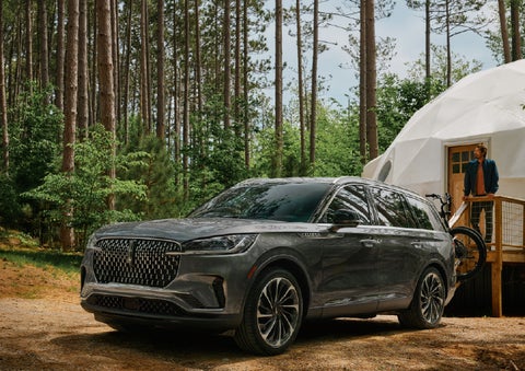 A 2027 Lincoln Aviator® is parked next to a high end glamping site. | Rogers Lincoln in Midland TX