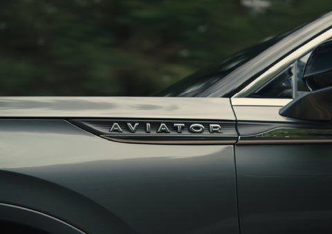 The driver’s side door and fender badging of a gray 2027 Lincoln Aviator® SUV are showcased. | Rogers Lincoln in Midland TX