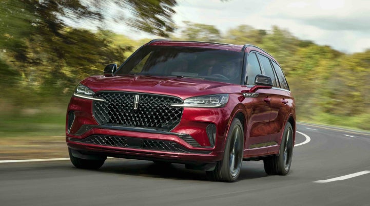 A 2027 Lincoln Aviator® SUV is being driven on a country road | Rogers Lincoln in Midland TX
