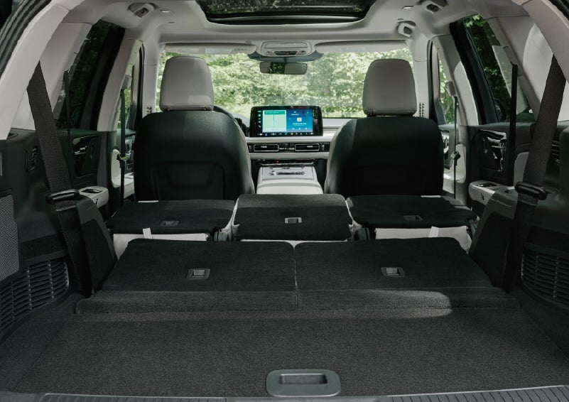 A rear to front view of the interior of a 2027 Lincoln Aviator® Black Label™ SUV shows the third and second rows folded flat | Rogers Lincoln in Midland TX